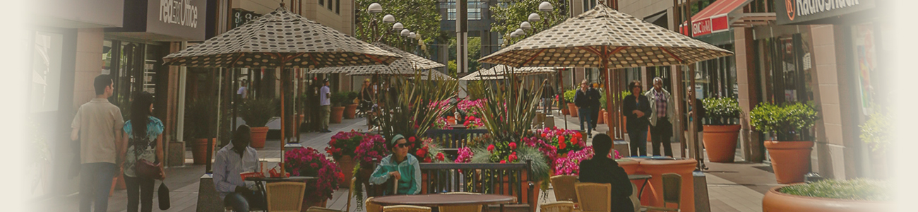 Commercial street of Oakland, with seats with umbrellas in the middle